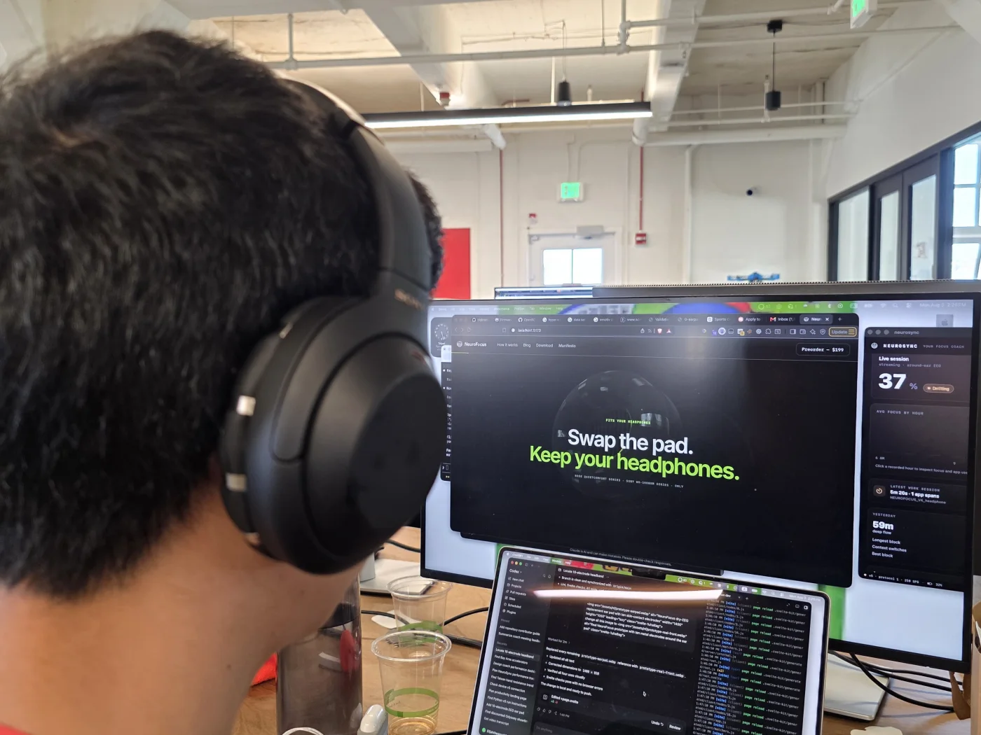 Tester wearing the real NeuroFocus EEG ear pad during a working session